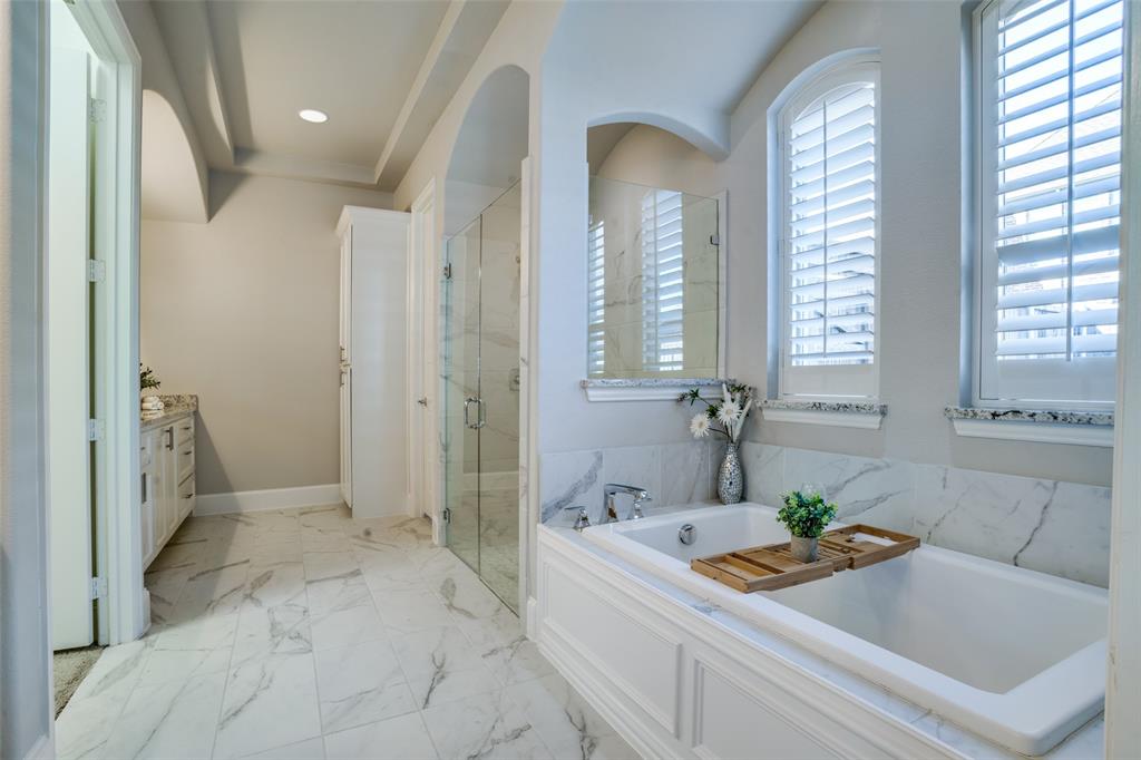 Primary bathroom with recessed lighting, a large shower, and a soaking tub