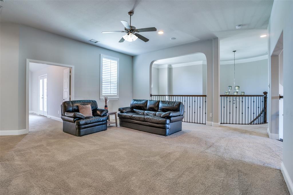 Upstairs big game room with ceiling fan