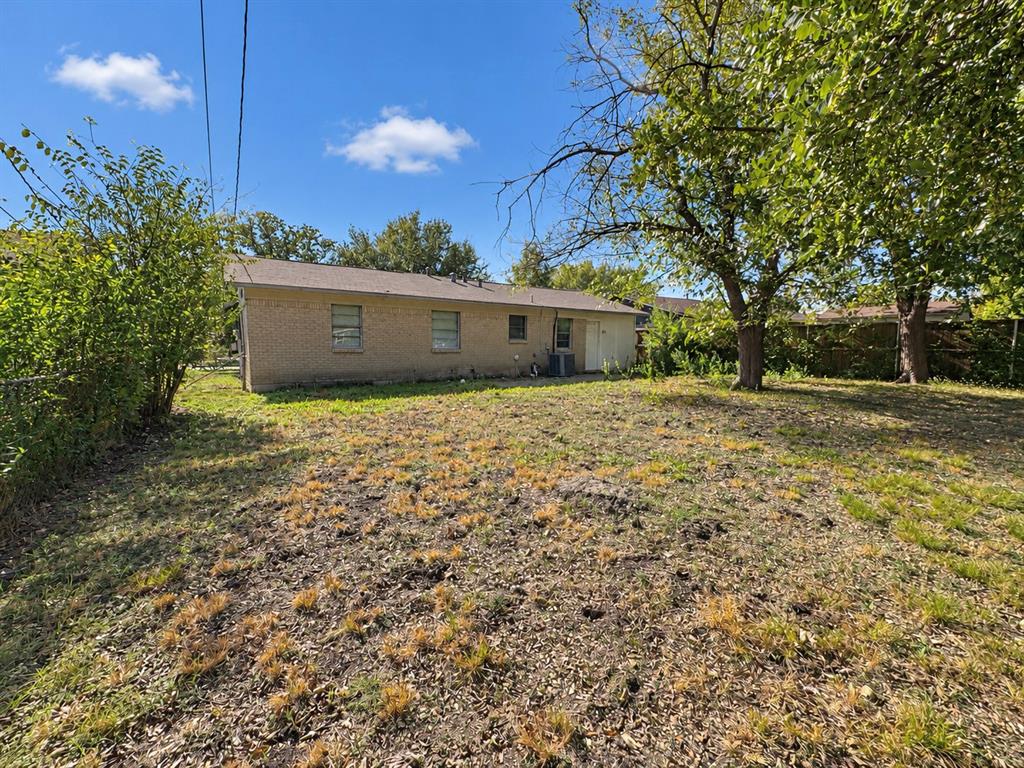 Brick exterior, expansive lot with mature trees, and perimeter fencing