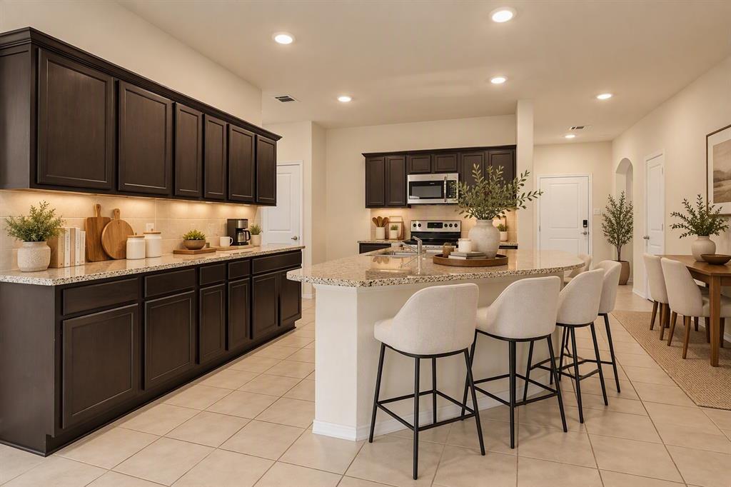 Virtually Staged Kitchen featuring dark wood cabinetry, stone countertops, a central island with integrated seating space, tiled flooring, and recessed lighting