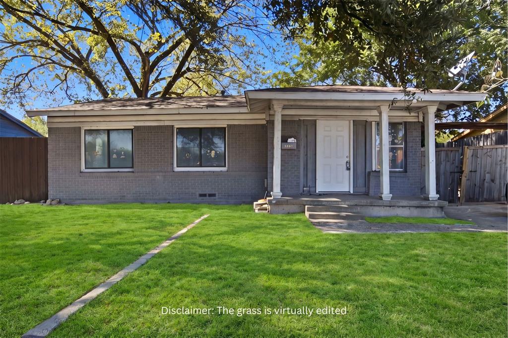 Single-story brick exterior featuring a covered front porch with column supports, horizontal siding accents, and mature tree canopy Single-story brick exterior featuring a covered front porch with column supports, horizontal siding accents, and mature tree canopy