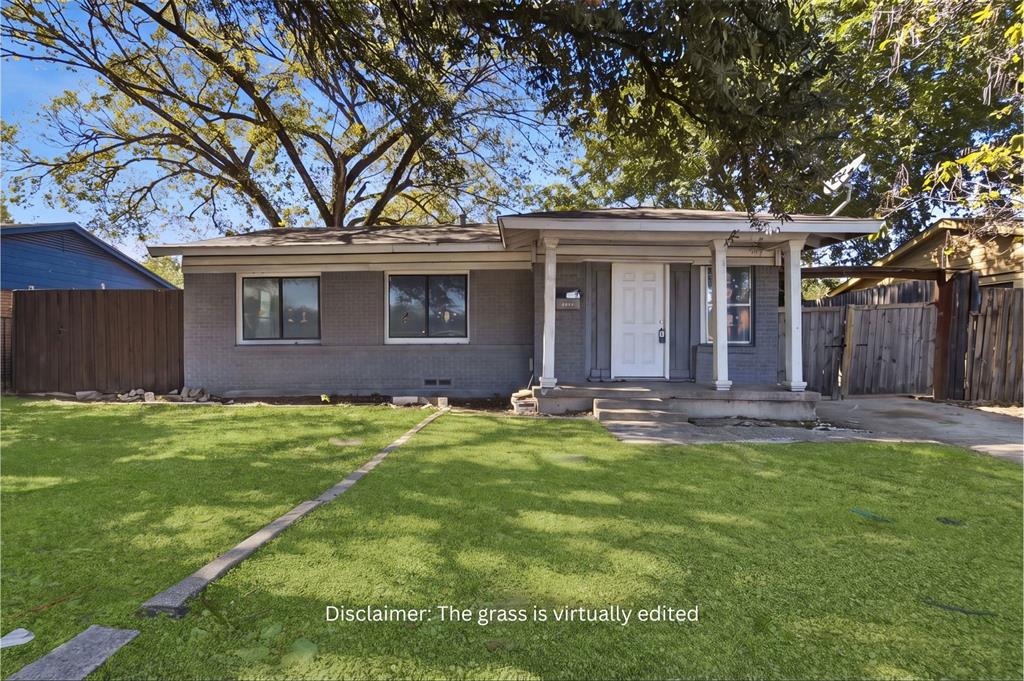 Single-story exterior featuring painted brick siding, a covered front porch with support columns, and wood-panel fencing Single-story exterior featuring painted brick siding, a covered front porch with support columns, and wood-panel fencing