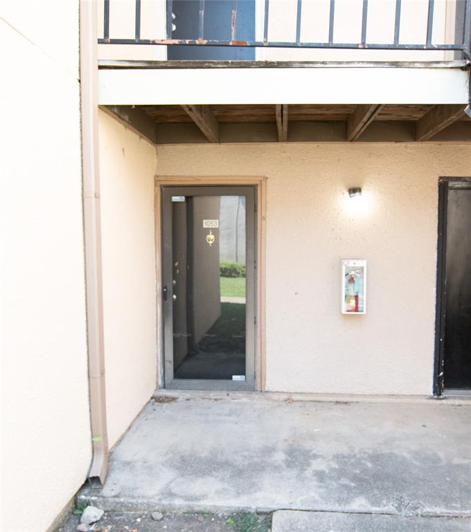 Entrance to property with stucco siding