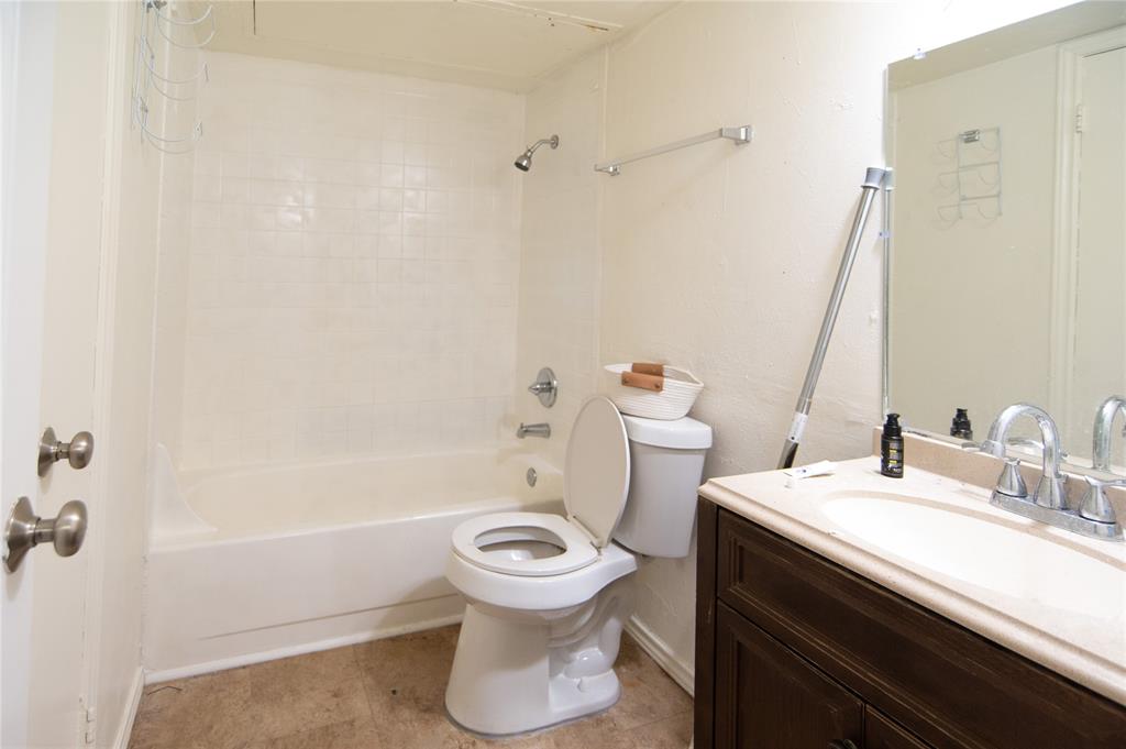 Bathroom featuring shower combination, vanity, and light tile patterned floors Bathroom featuring shower combination, vanity, and light tile patterned floors