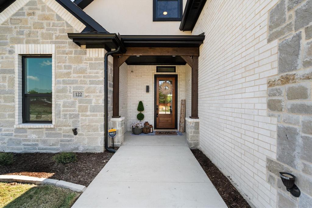 Gorgeous entry with an extended sidewalk, and cedar beams.