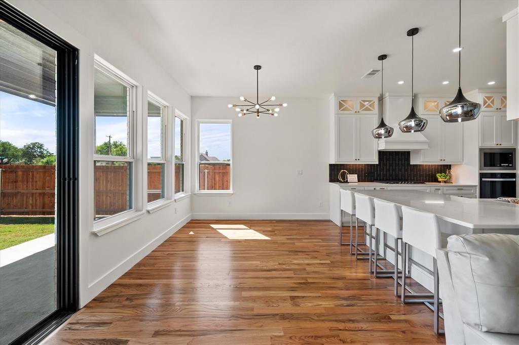 Eat in kitchen area with tons of daylight with all of the windows and 10' patio sliding door for indoor-outdoor living