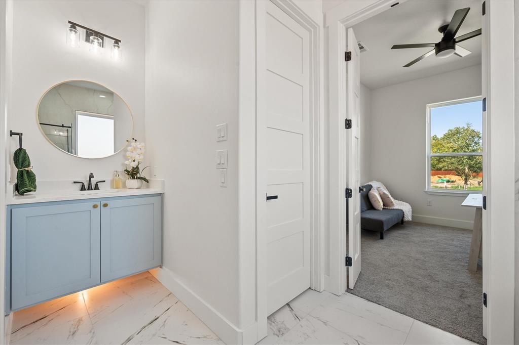 Mother in law ensuite bathroom with a floating vanity with under cabinet lighting & a quartz countertop.