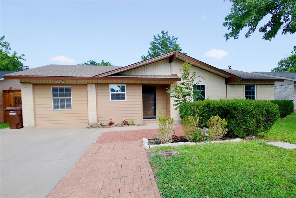 Single-story exterior featuring a brick and horizontal siding facade, low-pitch roofline, concrete driveway, and red brick paver walkway Single-story exterior featuring a brick and horizontal siding facade, low-pitch roofline, concrete driveway, and red brick paver walkway