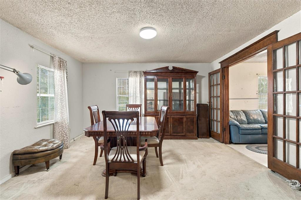 Interior space featuring built-in wooden cabinetry and French doors with wood-trim detailing