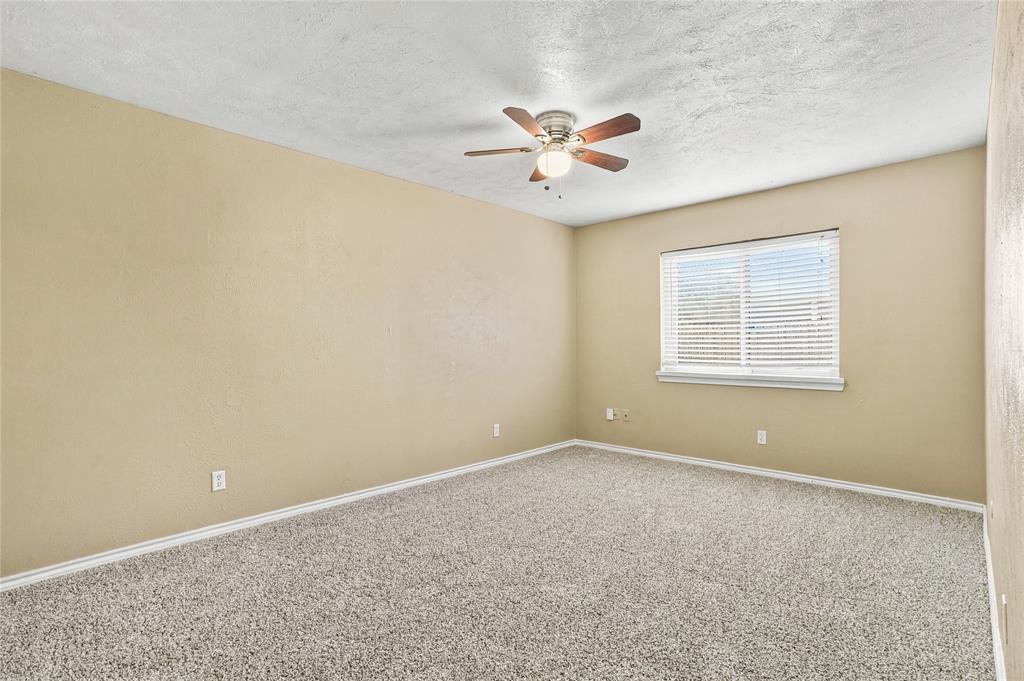 Bedroom with carpeted flooring, neutral finishes, a ceiling fan, and an open layout