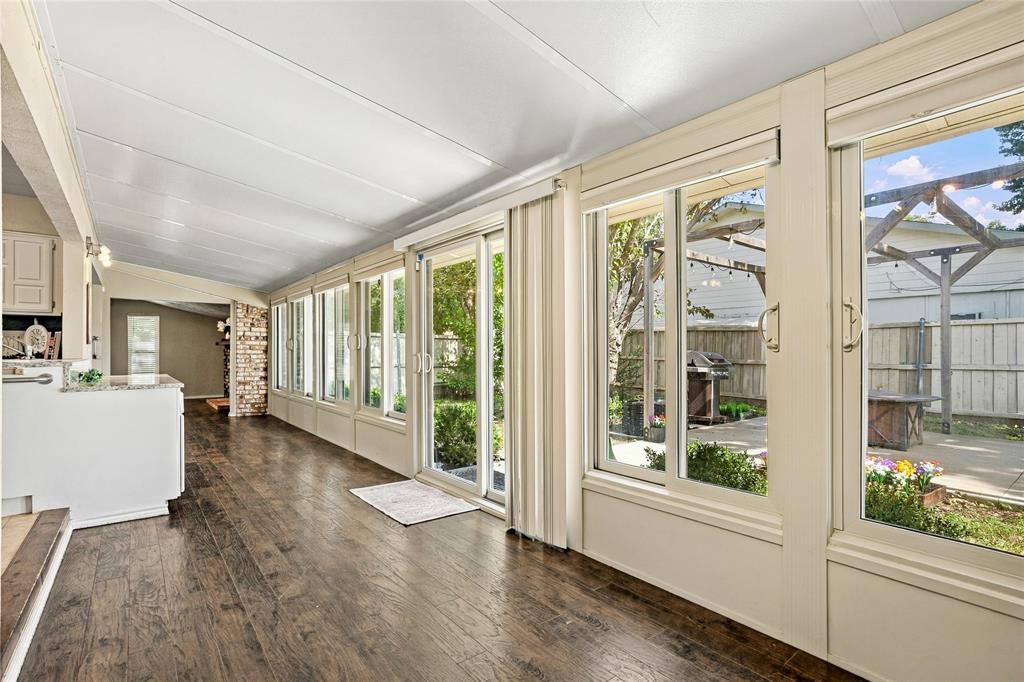 Additional sunroom view showcasing multiple windows, backyard views, and a light-filled space with flexible use options.
