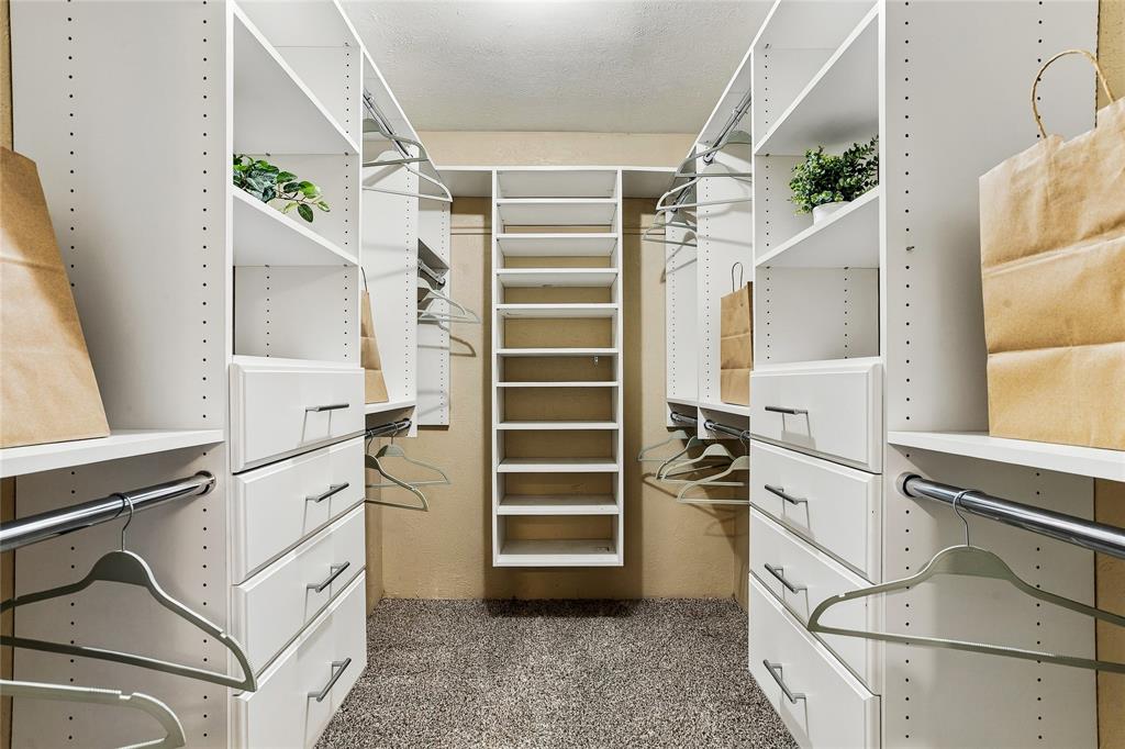Walk-in closet featuring built-in shelving, hanging space, and drawers for convenient storage and organization.