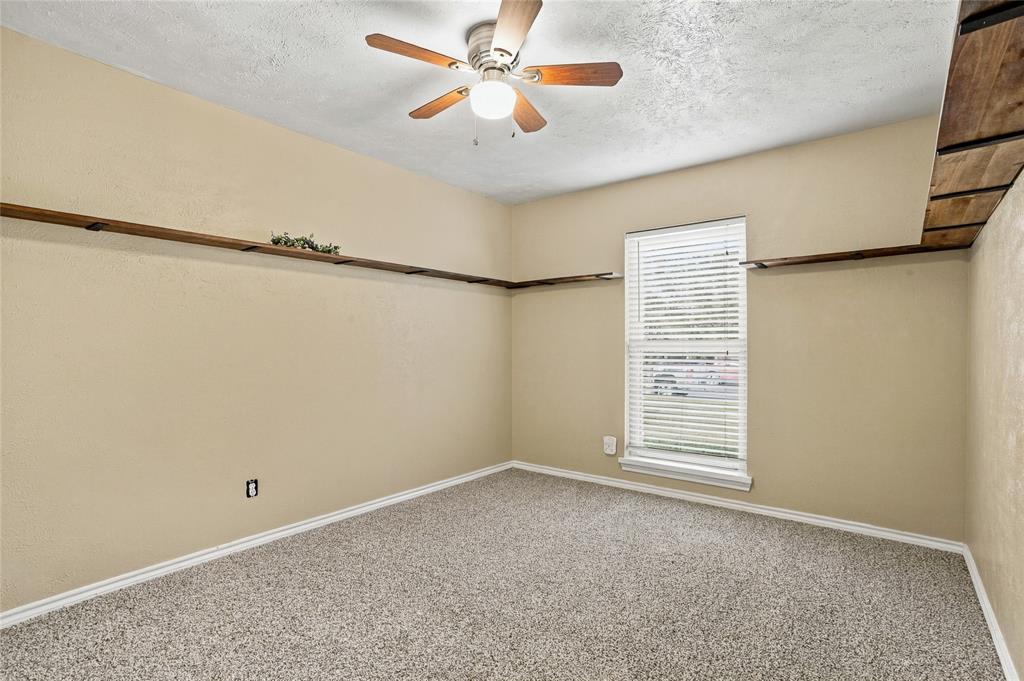Bedroom with carpeted flooring, neutral finishes, a ceiling fan, and an open layout