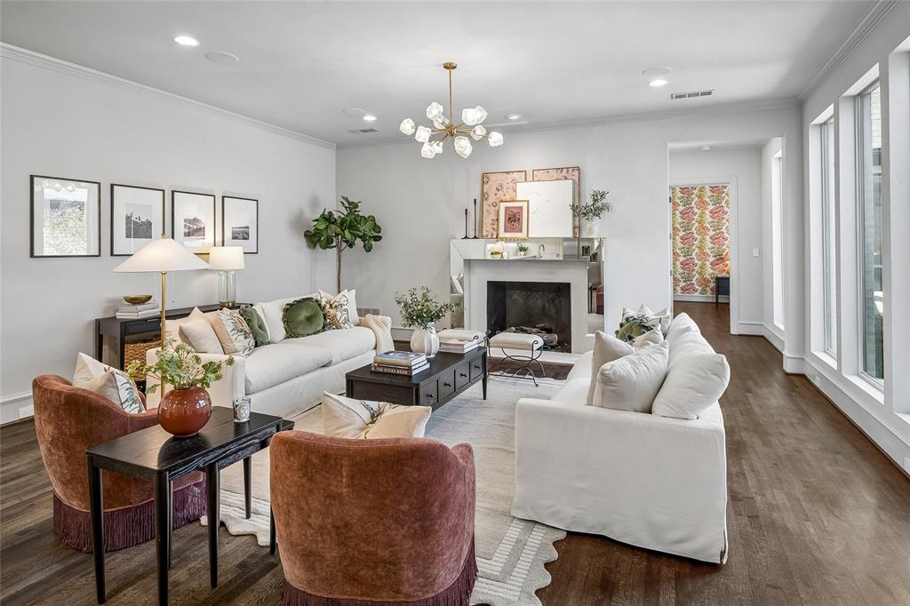 Spacious living area features a mirror-surround fireplace