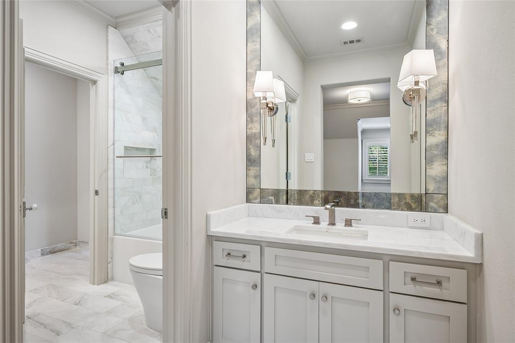 Adjoing bath has dressing-vanity areas for each of the two upstairs bedrooms