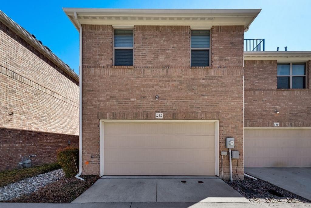 View of front facade featuring a garage