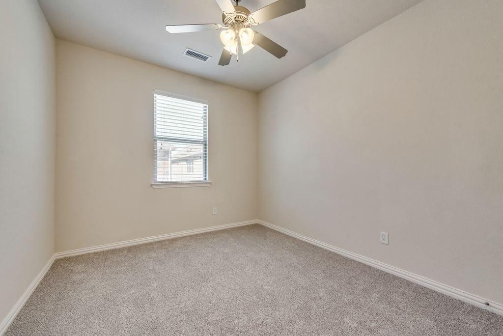 Unfurnished room with light colored carpet and ceiling fan