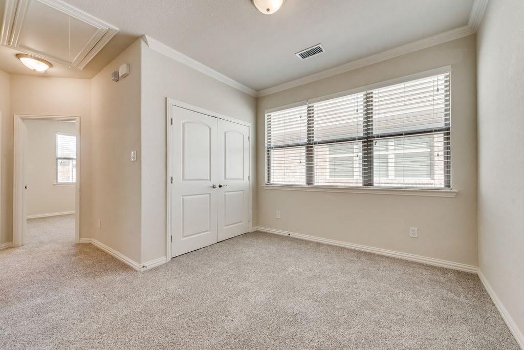 Unfurnished bedroom with multiple windows, light colored carpet, and a closet