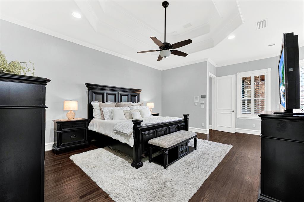 Clean, soft-toned walls provide a restful backdrop that accentuates the room's generous proportions and high ceiling lines. Imagine waking up rested on a quiet Sunday morning, watching rays of light trickle through the window shutters.
