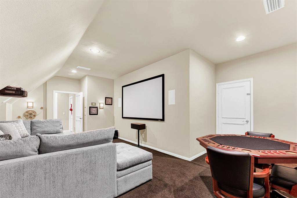 Recessed spotlighting and soft wall sconces provide customizable ambient light around the home cinema projection screen. It is a wonderful hideaway to host high-stakes poker nights or stream live sports weekend events.