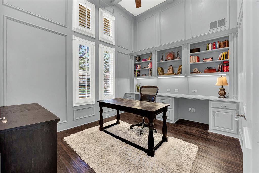 Soaring wainscoted walls and stacked multi-pane windows bring effortless brightness into this lofty study space. It is the perfect peaceful sanctuary to sip your morning espresso while reviewing the day's schedules before the house awakens.
