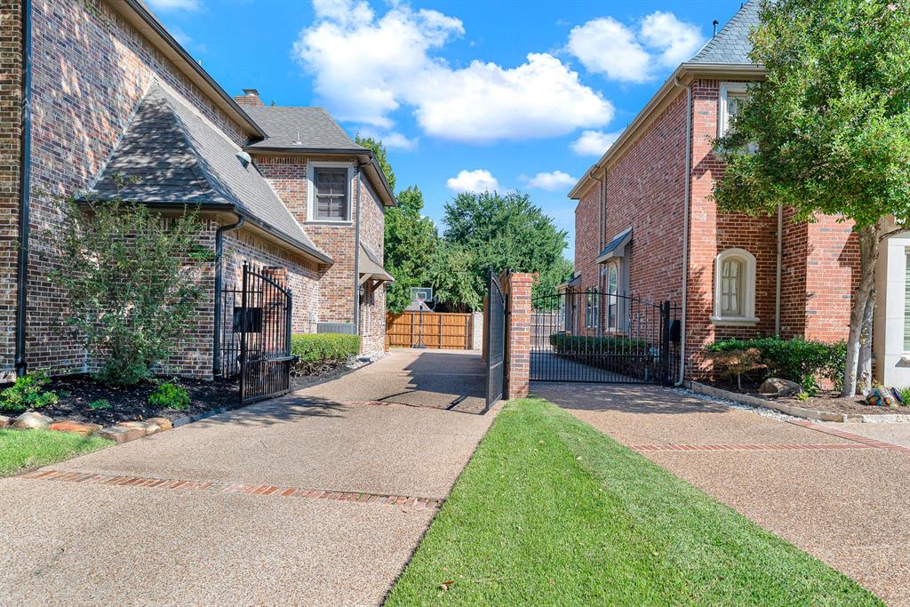 A black automatic metal gate provides access to the driveway, which leads to a large A black metal automatic gate provides access to the driveway, which leads to a double large parking area. Great for all kinds of activities.