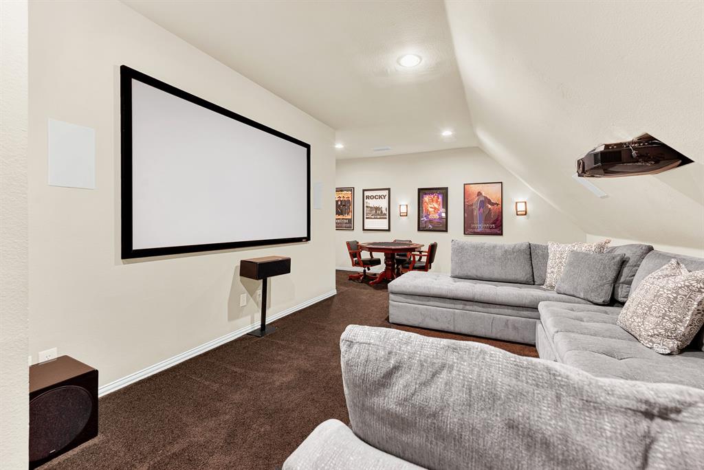 Angled attic ceilings create a authentic cinematic theater shape above plush wall-to-wall carpeting. Picture gathering the family together with freshly popped popcorn for an immersive Friday night movie marathon.
