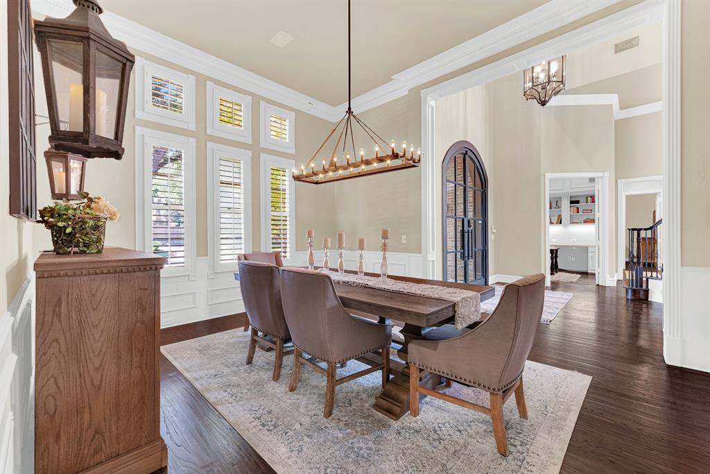 Soaring open archways integrate the dining space seamlessly with the surrounding foyer and dark wood flooring. You will love serving a festively prepped weekend brunch as natural sunlight pours through the shuttered windows.