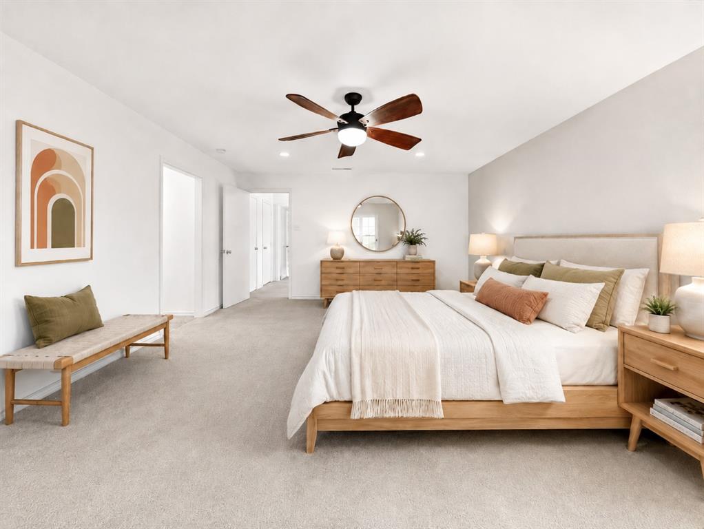 Neutral-toned wall-to-wall carpeting, recessed lighting, and a dark-finish ceiling fan with integrated lighting