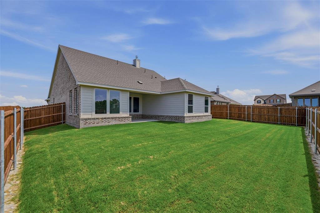 Expansive lawn bordered by wood fencing
