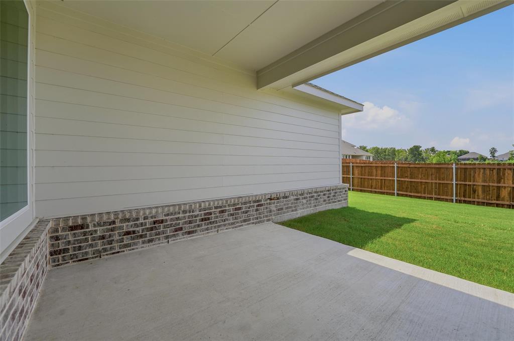 Expansive outdoor patio with concrete flooring, covered ceiling, and brick and siding exterior