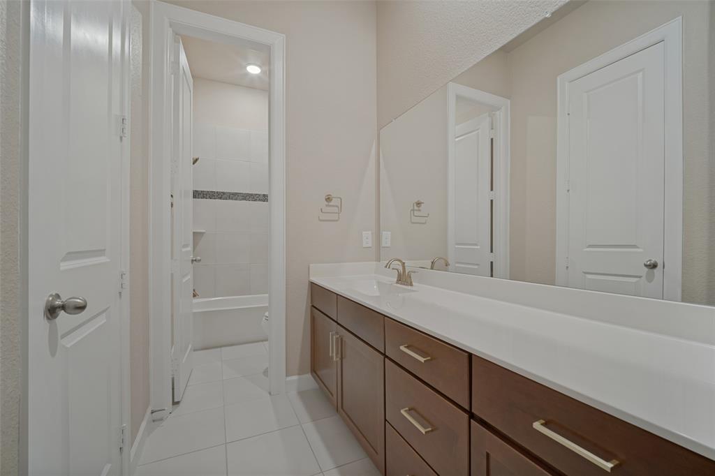 Guest bathroom with large prep area separated by the toilet and shower