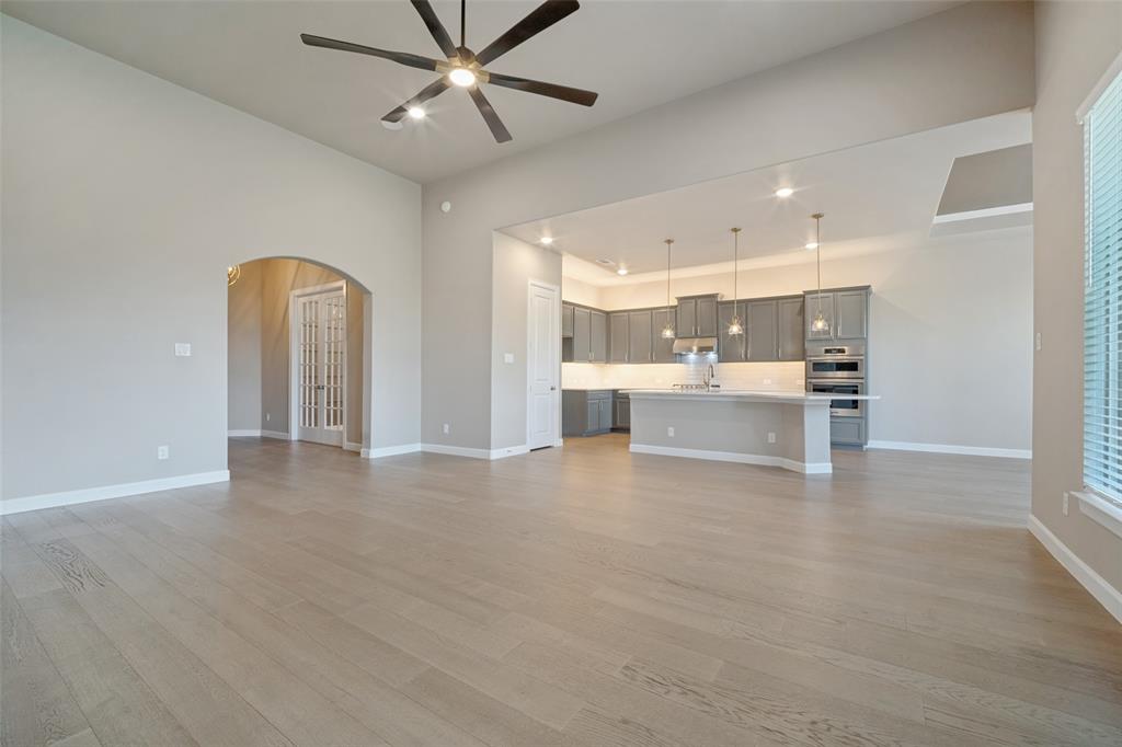 Open living and dining room space with stunning light wood-look flooring seamlessly blending the spaces together