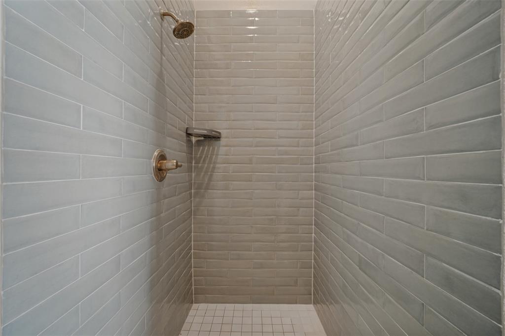 En suite primary bathroom with dual sinks, a separate soaker tub and walk in shower