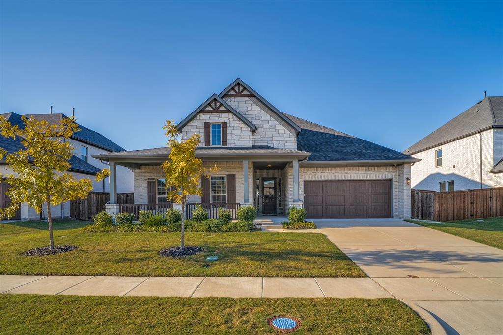 Welcome home to this stunning home in Sonoma Verde with a large front porch and white stone facade!