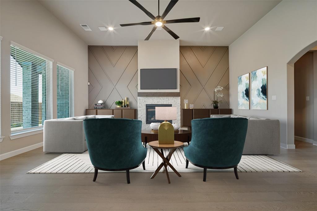 The living room features the same beautiful wood-look flooring, accent walls bookending a cozy fireplace, and flooded in natural light; Virtually staged