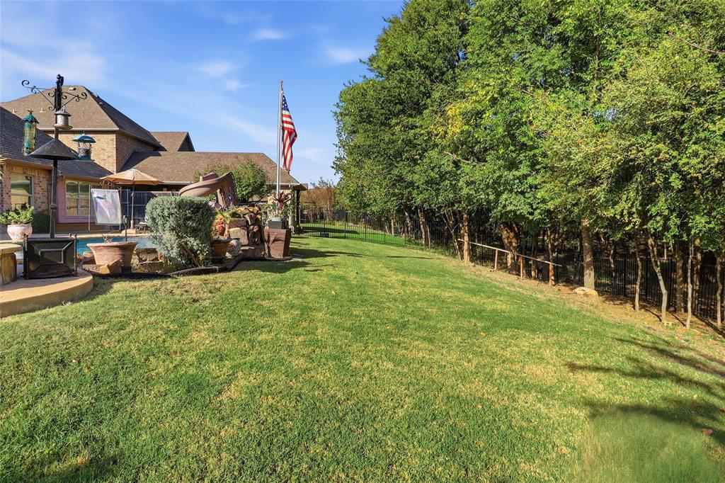 Behind Pool with large grass area