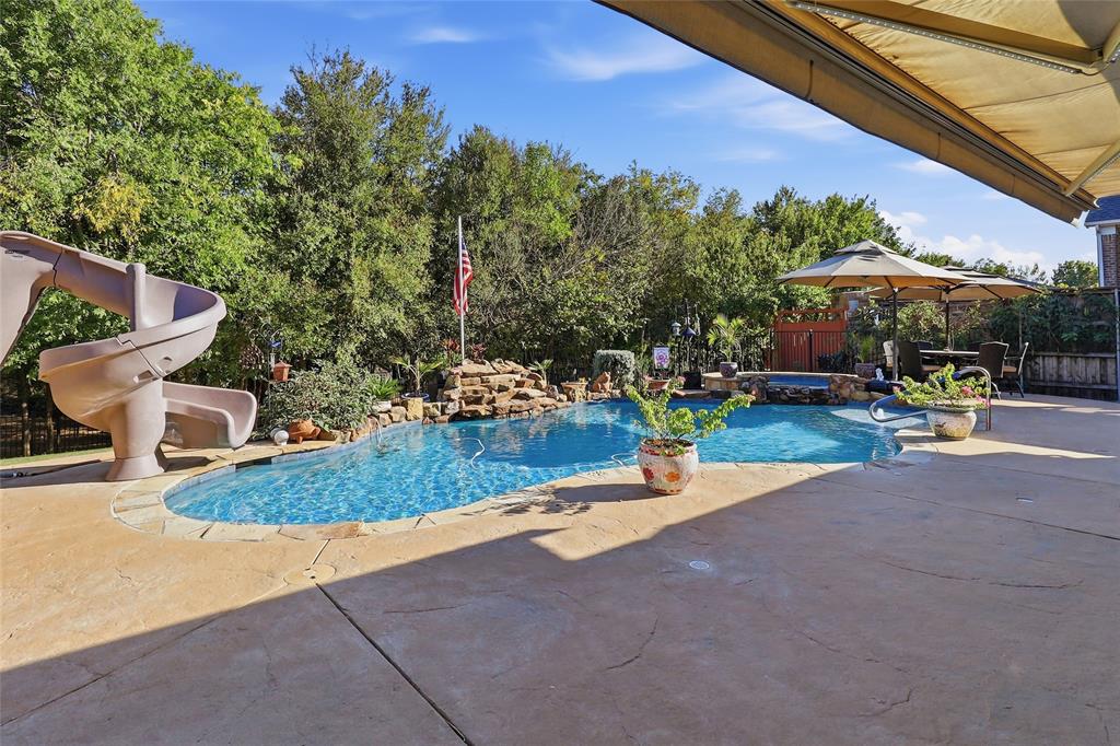 Pool has slide and water fall
