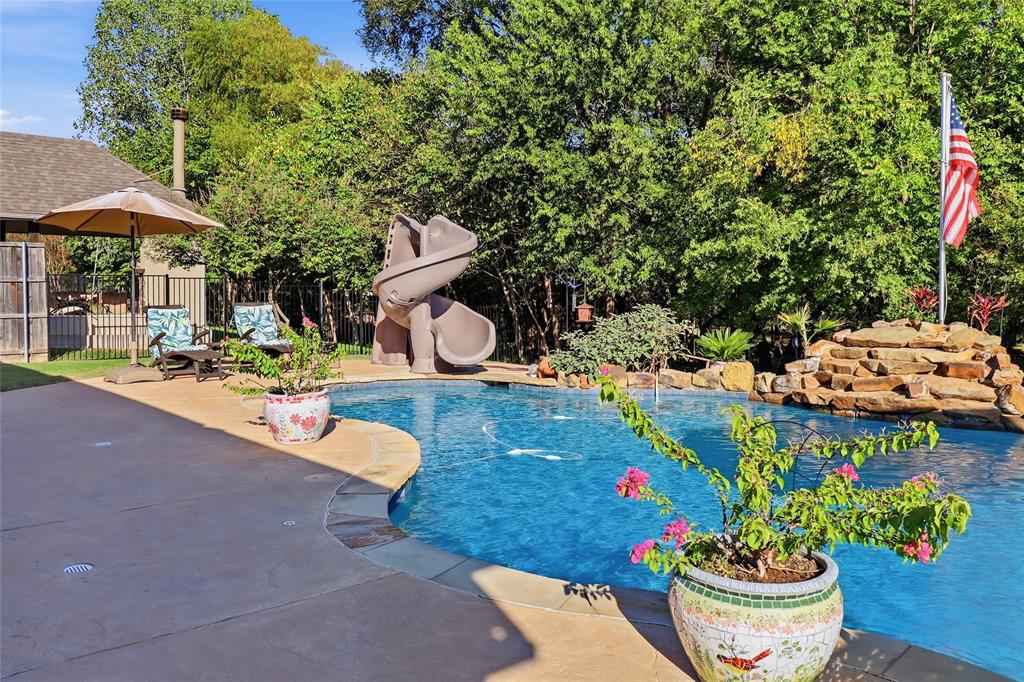 View from covered patio to slide and waterfall.