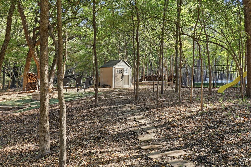 Stone walkway to firepit and storage shed.