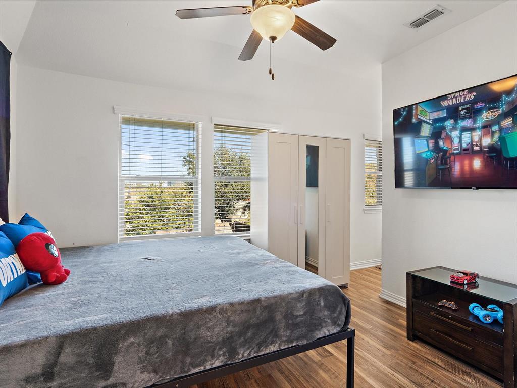 Bedroom featuring wood finished floors, ceiling fan, and a closet
