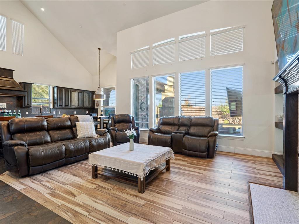 Living area with high vaulted ceiling and wood finish floors