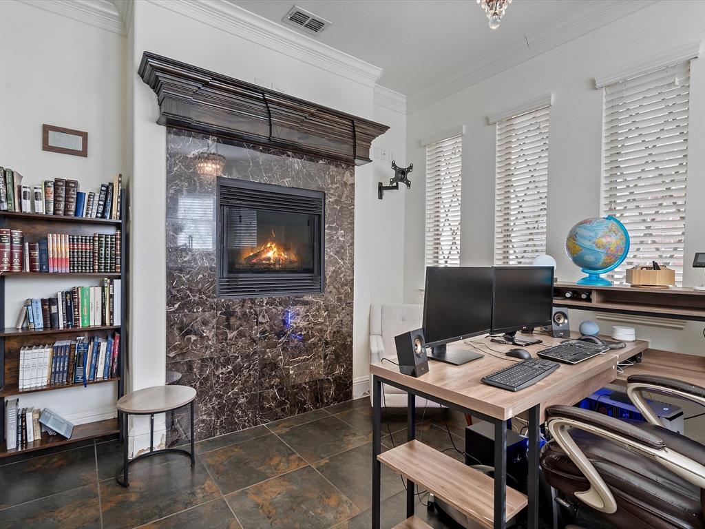 Office featuring ornamental molding and a premium fireplace