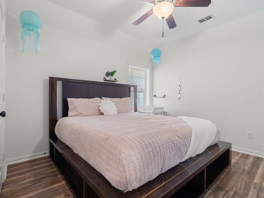 Bedroom with dark wood-type flooring and ceiling fan