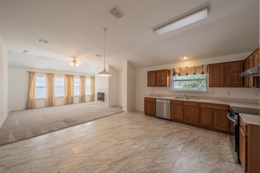 Kitchen featuring wood cabinetry, stainless steel appliances, and solid surface countertops
