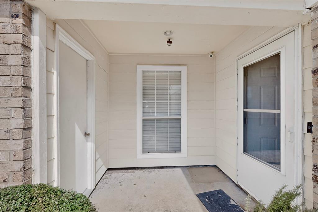 Covered entryway featuring light-toned horizontal siding, brick facade accents, a multi-pane window with blinds, and an exterior storage closet door Covered entryway featuring light-toned horizontal siding, brick facade accents, a multi-pane window with blinds, and an exterior storage closet door