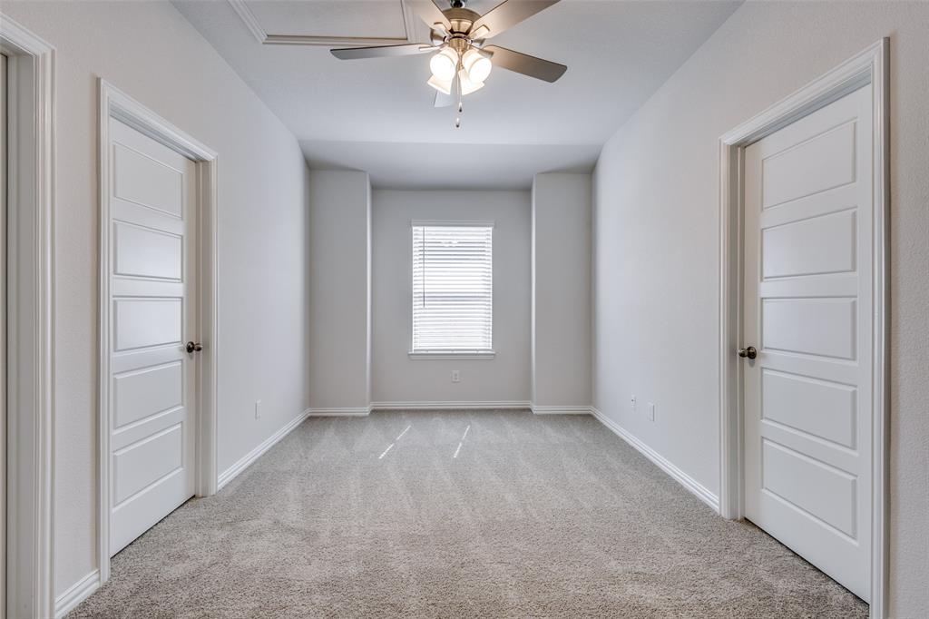 Unfurnished room featuring baseboards, light carpet, and ceiling fan
