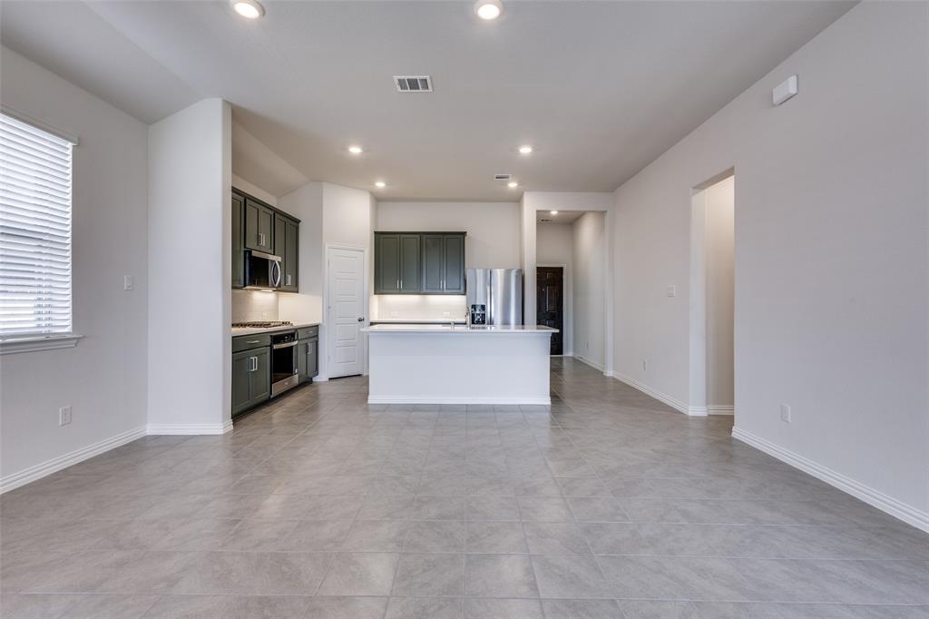 Unfurnished living room with light tile patterned flooring, baseboards, visible vents, and recessed lighting