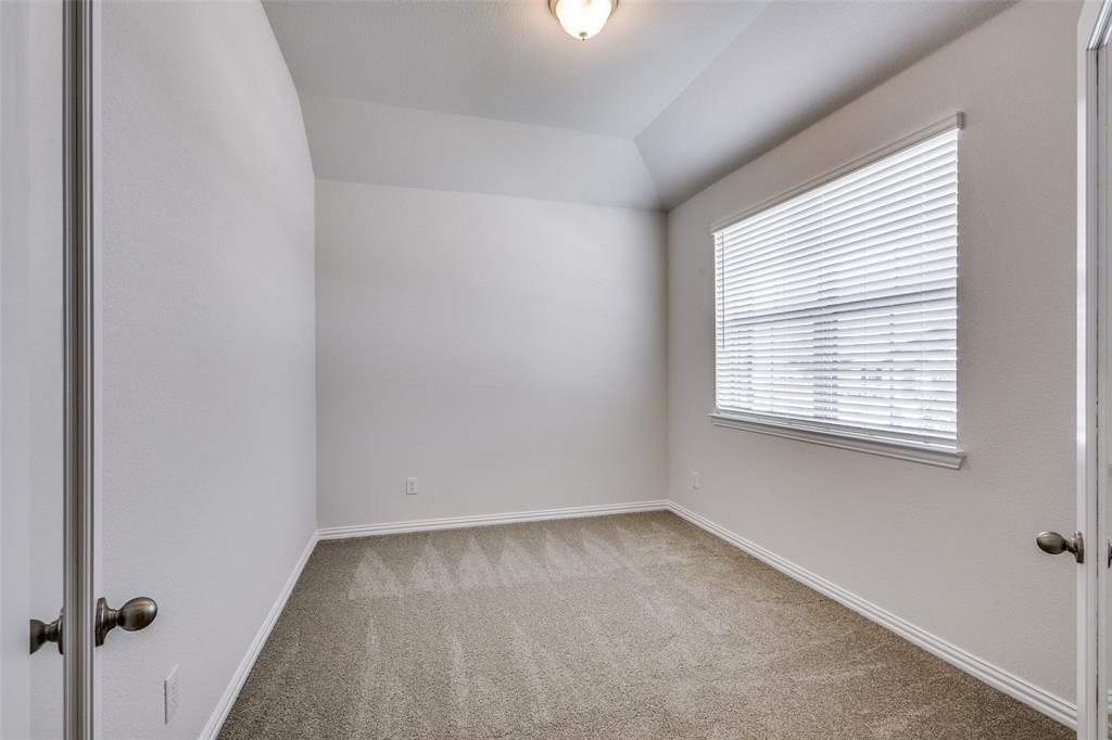Carpeted spare room with baseboards
