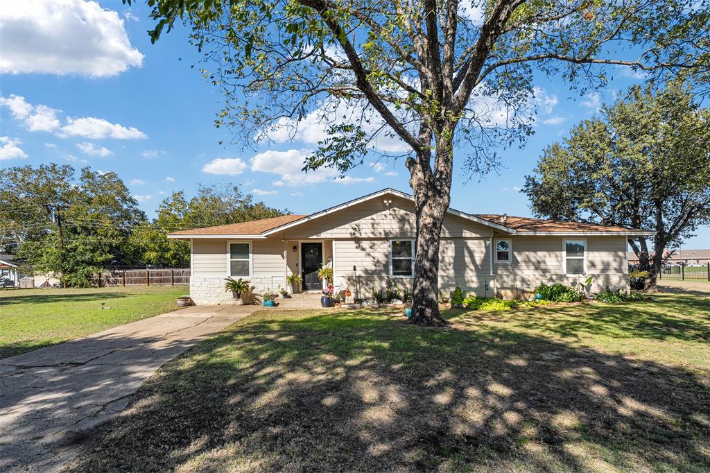 Single-story exterior featuring stone veneer accents, lap siding, a concrete driveway, and mature landscaping Single-story exterior featuring stone veneer accents, lap siding, a concrete driveway, and mature landscaping